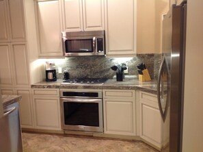 Granite counters separating stove cook top and oven.