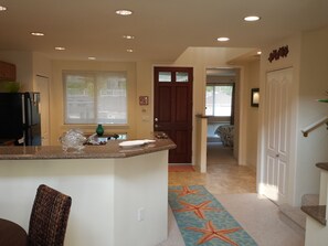 Entry, kitchen and guest room.