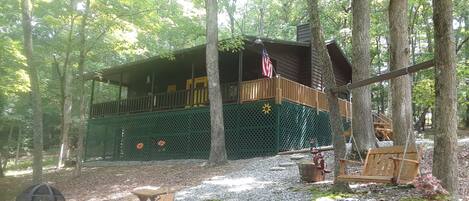 plenty of outdoor space with hot tub, fire pit, swing and picnic table