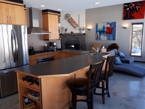 The KITCHEN is the heart of the house, with the living room to the right and the dining area to the left.