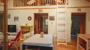 View from the entrance with bedrm at right, ladder to loft, and bathrm in center