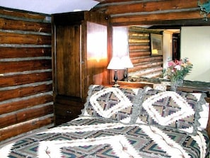 Cozy log bedroom with queen bed.