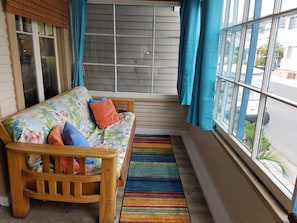 Sunporch with large windows that open to the street - ocean view