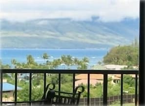 Wrought iron patio furniture overlooking the ocean and West Maui Mountains