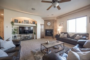 Spacious Living Room with Cozy Fireplace and 65" Smart TV