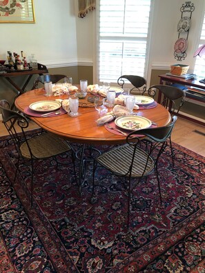 Dining room with service settings for up to 8 people. 