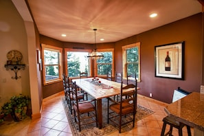 Large dining room with oversized table that can seat up to 12. Large bay windows