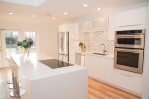 Kitchen, induction cooktop, garage door cabinets.