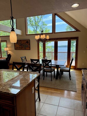 Vaulted ceilings make for beautiful & dramatic views of the lake and woods.