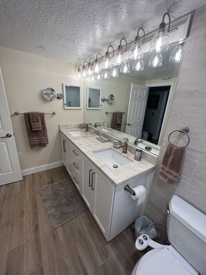 Brightly Lite Bathroom With Toilet And Adjustable Bidet. 