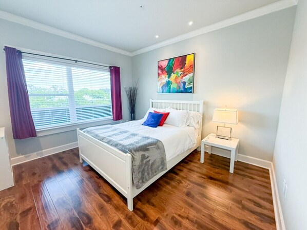 Wake up to sweeping views of Portland from the master bedroom—this top-floor suite features natural light, bold artwork, and plush comfort for a restful stay.