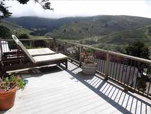 Chaise lounges on deck ovelooking mountains, beach, ocean