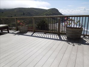 Large deck running length of home with ocean, beach and mountain views