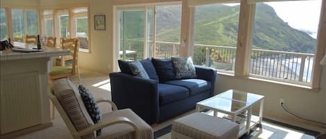Living room overlooking the beach, ocean and mountain range