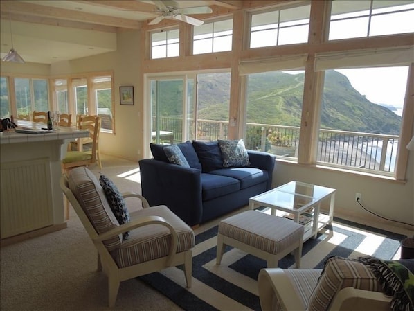 Living room overlooking the beach, ocean and mountain range