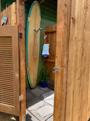 Outdoor shower with privacy fence and hot water