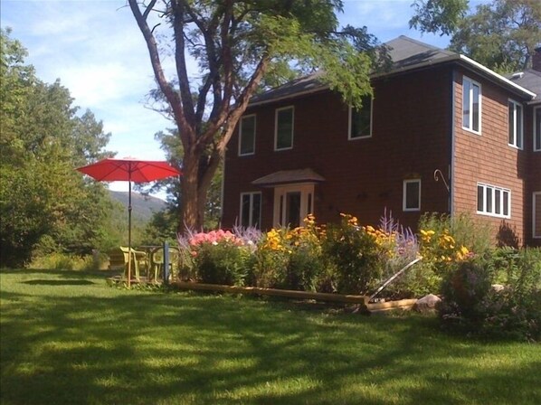 Enjoy the grassy lawn, perianal flower garden  and deck for BBQ & outdoor dining