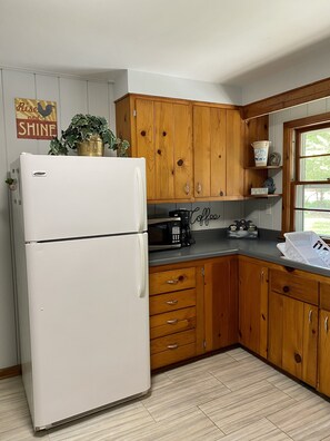 Kitchen with microwave and coffee maker. No dishwasher.