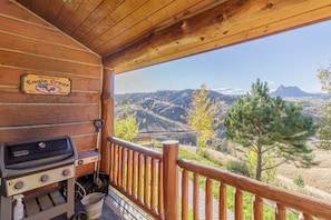 Front deck at Eagle Crest cabin offers a propane grill and sitting area to take in the stunning mountain views!