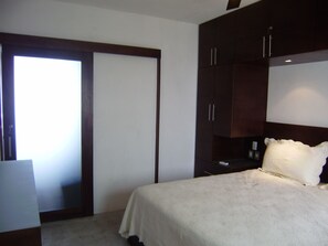 Bedroom has frosted, sliding glass door