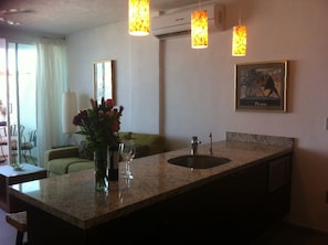 Kitchen area opens to living room and balcony