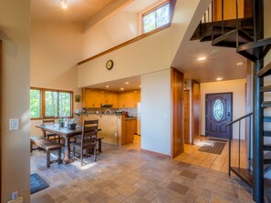 Dining room with table that seats 8+, modern kitchen and more panoramic windows.