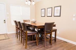 Main floor dining area with seating for 8, and adjacent seating for 6 at island.