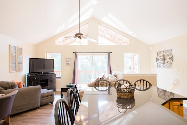 Main/top floor living room with plenty of seating in dining area and kitchen.