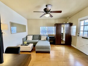 Walk thru the front door and into the living room which includes a comfortable sectional couch and wardrobe closet for extra storage (luggage, personal belongings, etc).