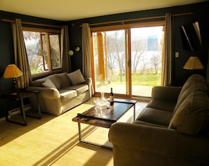 living room with vineyard walkout, awesome lake and sunset views!  queen pullout