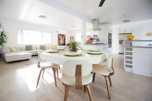 Dining table seats up to 8 with clear view of adjustable 66" flatsceen TV.