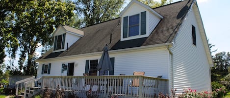 Huge full length deck. Table with 6 chairs, Adirondack chairs, & charcoal grill