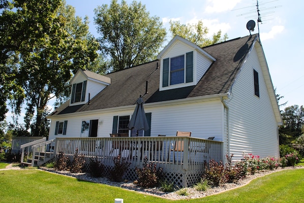 Huge full length deck. Table with 6 chairs, Adirondack chairs, & charcoal grill