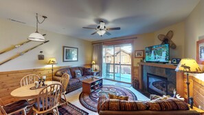 Living room with nearby kitchen and door to deck: Truckee Cinnabar Vacation Retreat