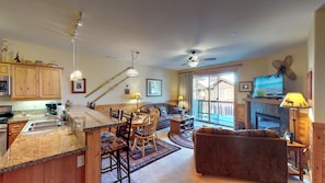 Living room with nearby kitchen and door to deck: Truckee Cinnabar Vacation Retreat