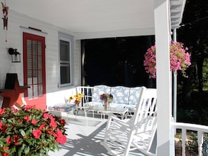 View on front porch with vintage furniture.