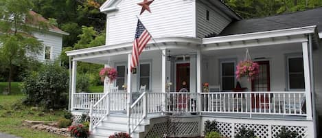 WHOM greets you with a large front porch and U-shaped driveway for parking.