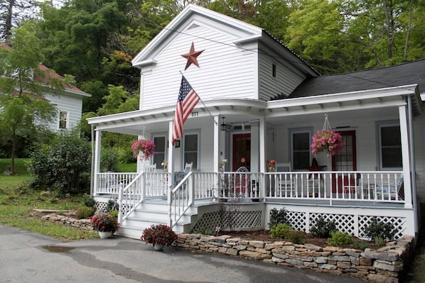 WHOM greets you with a large front porch and U-shaped driveway for parking.