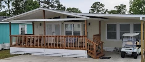 House with large deck and covered golf cart parking. Up to 3 cars can park. 