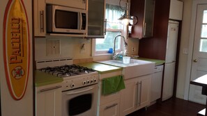 Kitchen with gas stove, dishwasher, microwave, washer and dryer