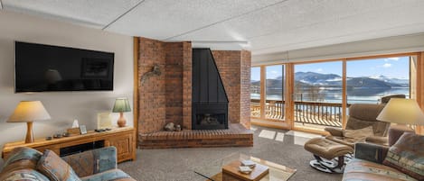 Family room TV, fireplace, queen size sofas and deck sliding glass door