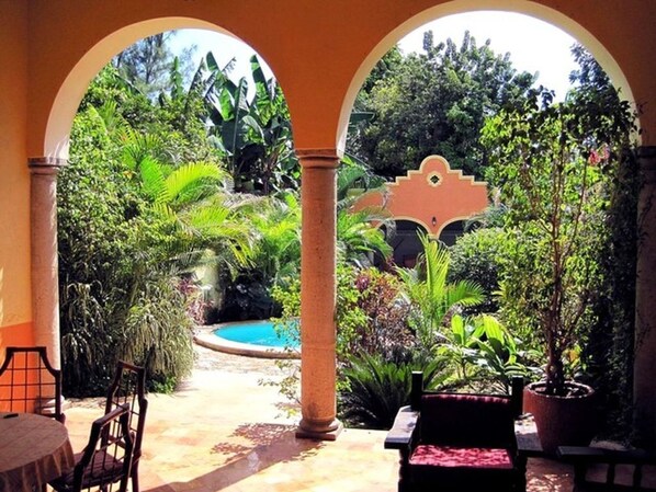 Covered Terrace Overlooking Pool and Garden