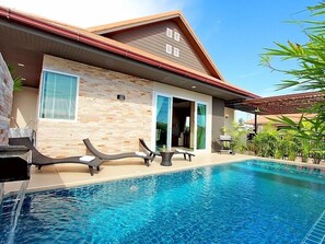 Living area leads to swimming pool area with built-in jacuzzi seat and kid pool