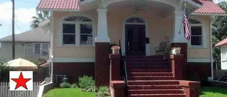 apartment is on first floor, through white picket fence (left side of house)