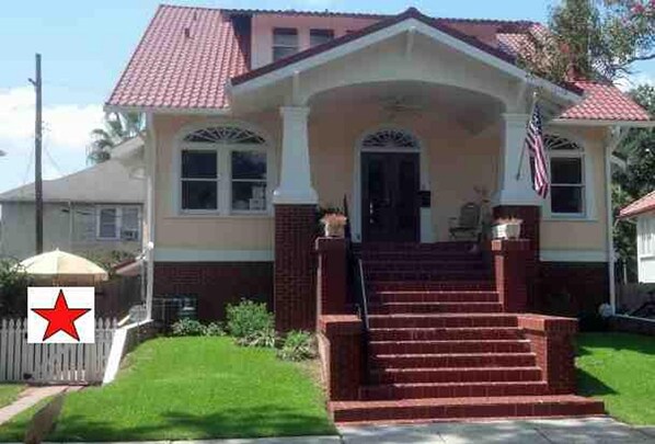 apartment is on first floor, through white picket fence (left side of house)