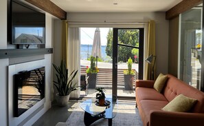 Living room with ocean view and electric fireplace