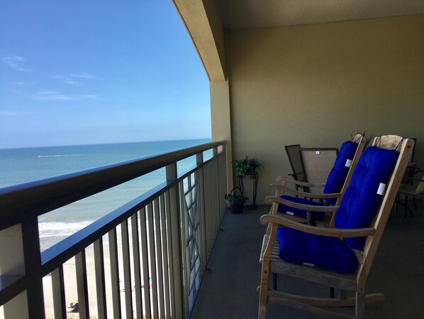 Large balcony with 2 rockers, 2  loungers and dining table