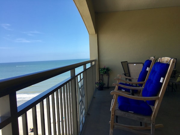 Large balcony with 2 rockers, 2  loungers and dining table