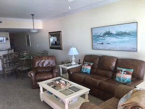 Living room with leather recliner and sofa with two reclining ends