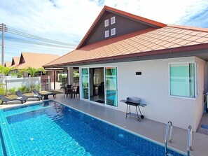 Living area leads to swimming pool with kid area.